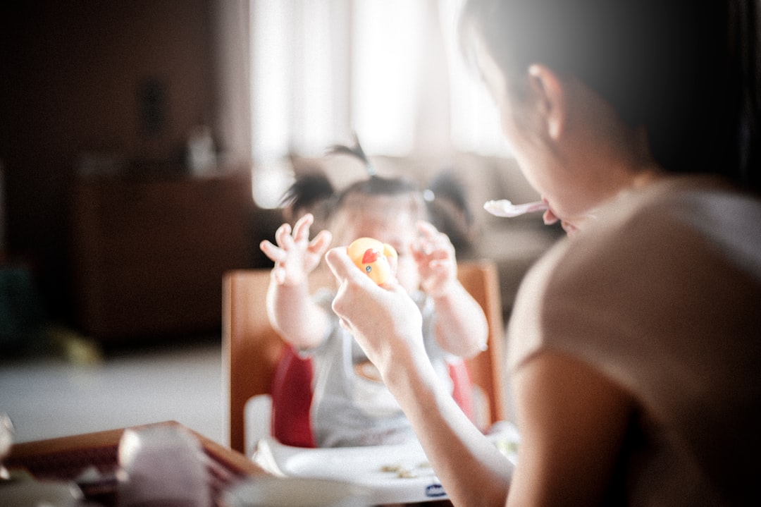 Feeding a Baby by Best Kids Tablets selective focus photography of woman feeding baby